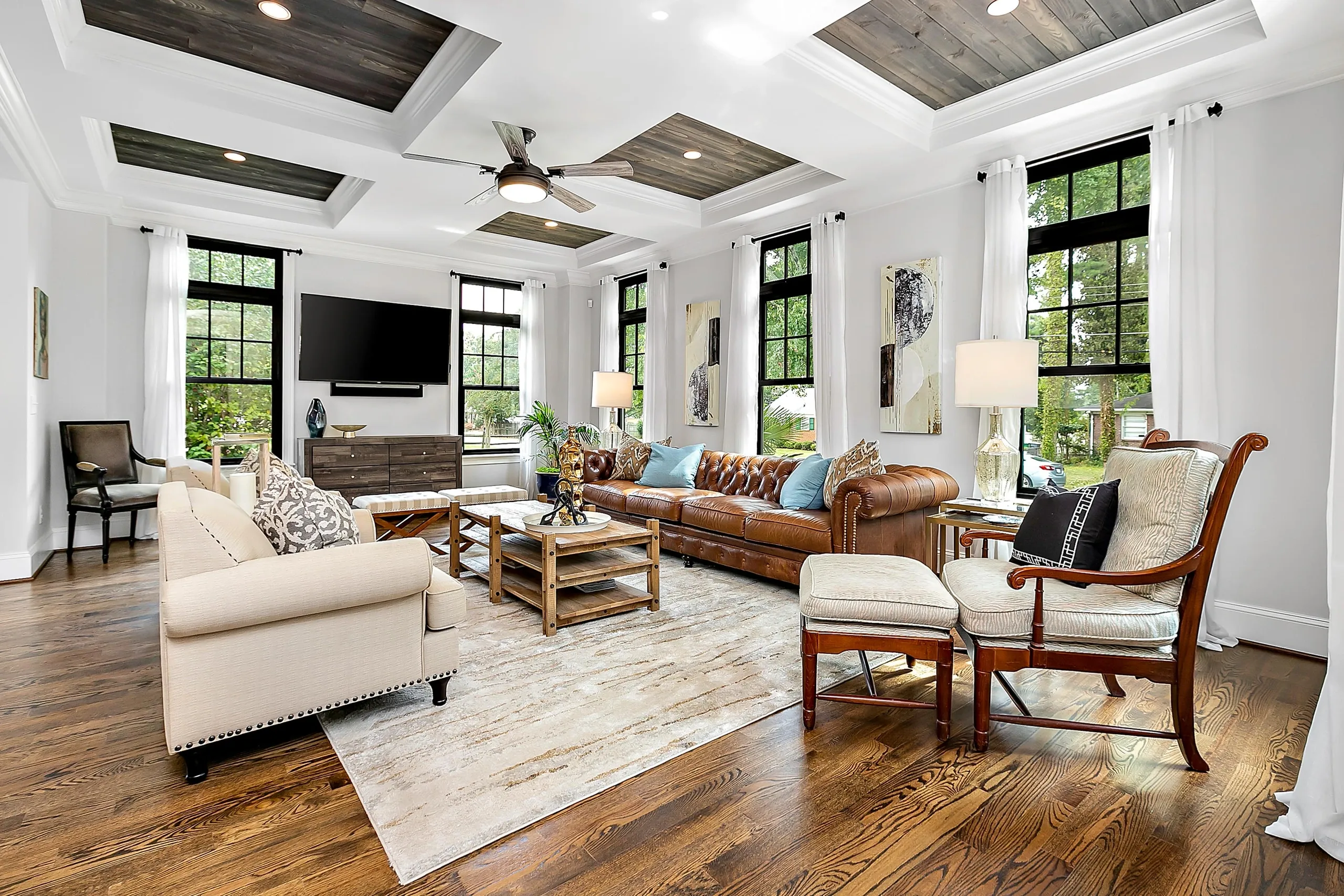Completed M22 Construction living room — coffered ceiling, hardwood floors, natural light