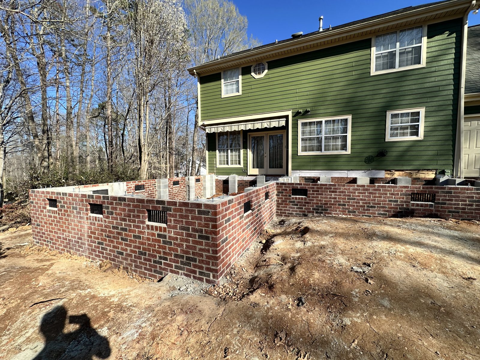 M22 Construction home addition in Charlotte with new brick foundation and masonry