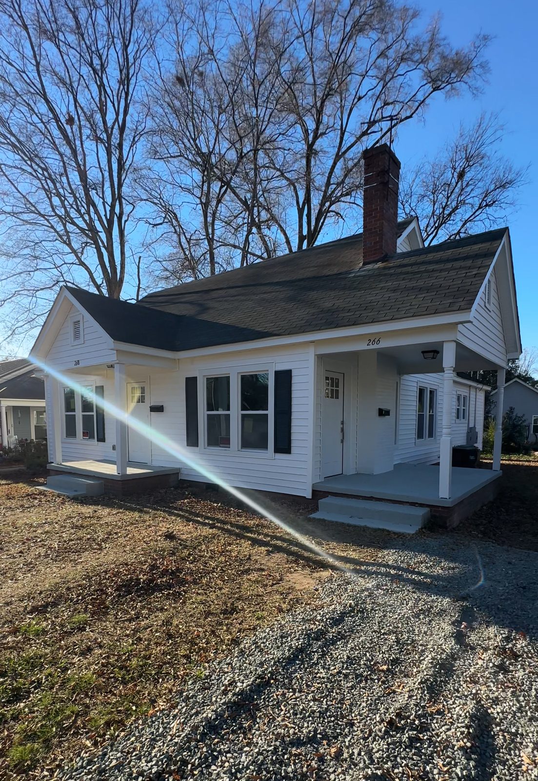 M22 Construction whole-home renovation in Charlotte, refreshed white cottage exterior