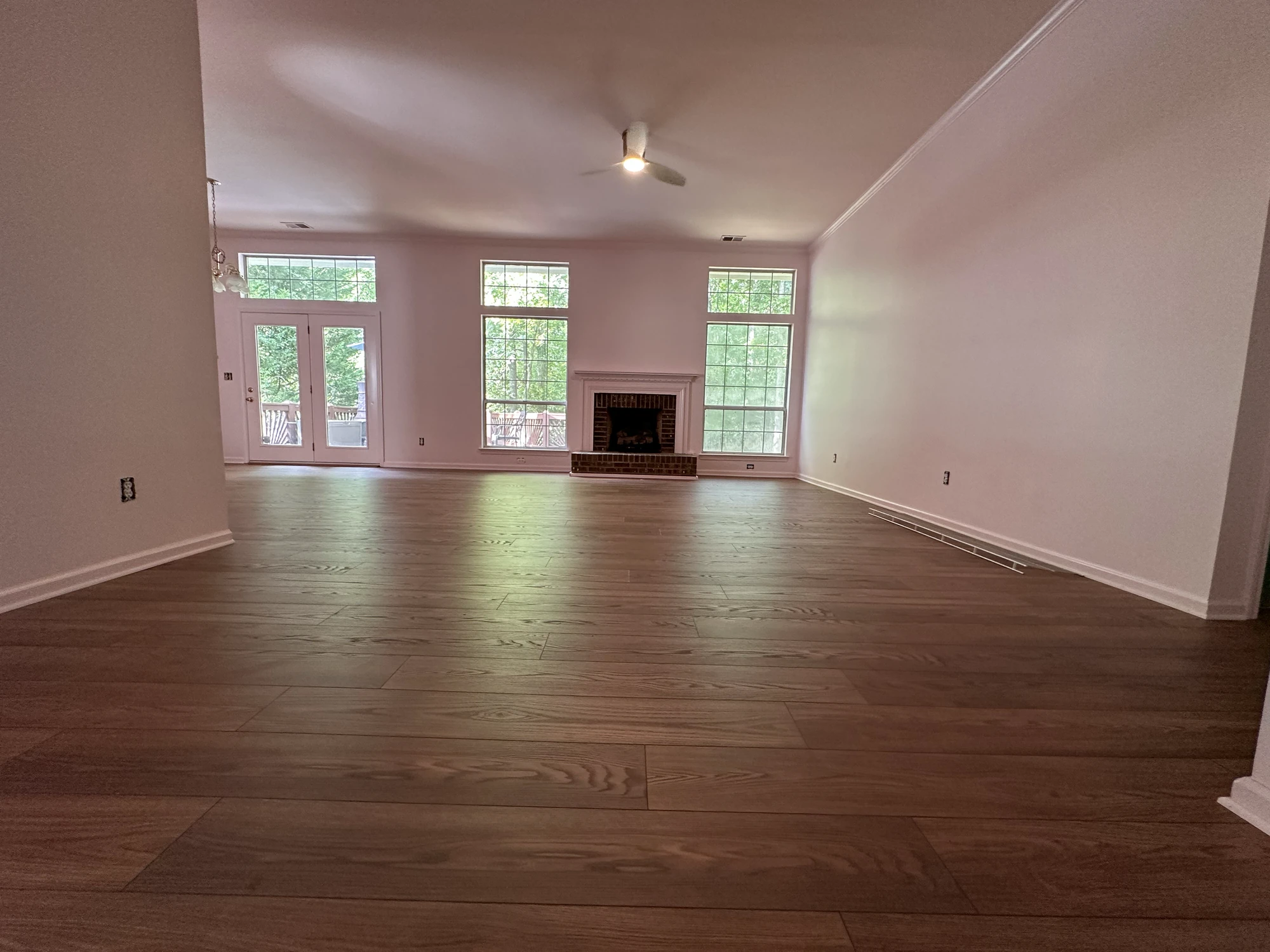 M22 Construction whole-home renovation — open living area with hardwood floors